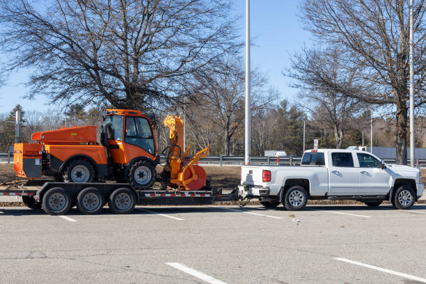 istock Pickup truck towing road construction machine 1390875794