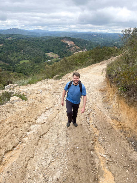 istock Man hiking up on a road 1390876759