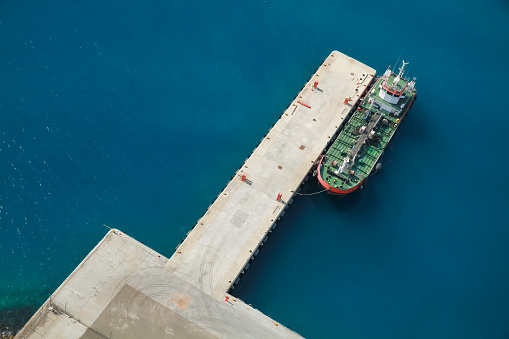 Tanker ship with green deck is moored in Jedda port, Saudi Arabia. Aerial view