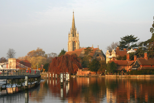 All Saints Marlow Church on the river thames with the weir on the left.