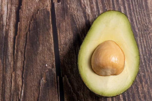 istock Avocado on wooden background 1390877790