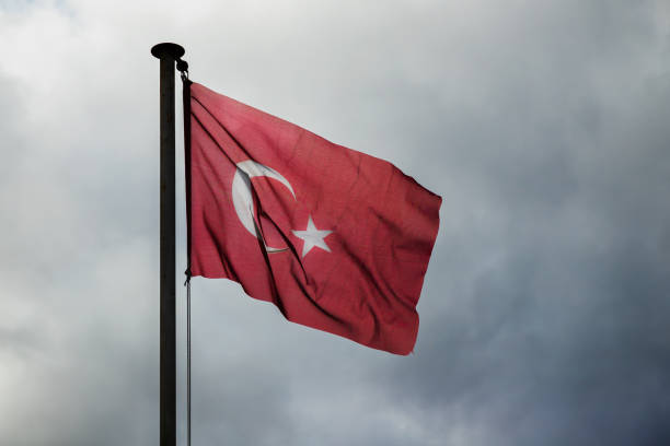 istock Flag of Turkey is under stormy sky 1390877996