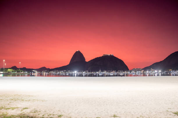 sky with the color red, under the influence of the ashes of the volcano of tonga in the cove of Botafogo in Rio de Janeiro. stock photo