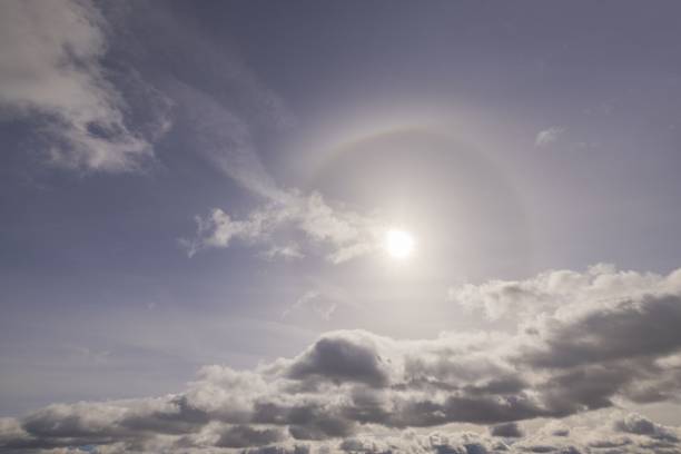 istock Beautiful view of sun breaking through cloudy spring sky. 1390878826