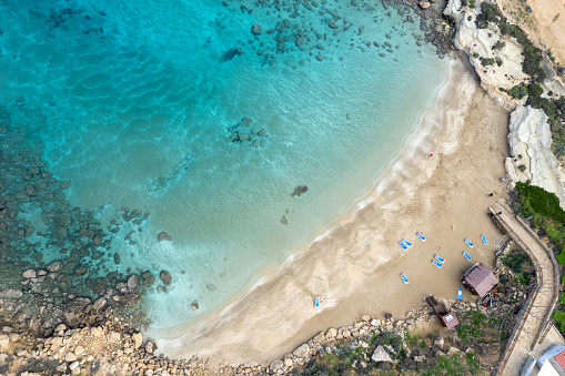 Aerial view from flying drone of empty sandy beach with golden sand in winter. Protaras Cyprus