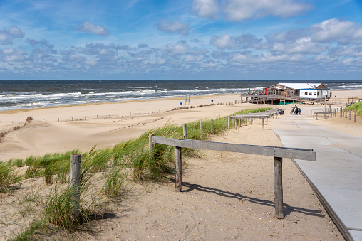 Sandy beach with pavilion.