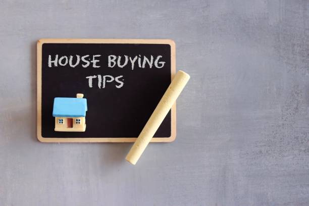 istock Chalkboard with text HOUSE BUYING TIPS, toy house and chalk. 1390880053