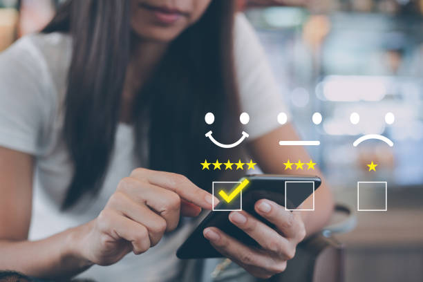 istock Customer service satisfaction survey concept,Woman using smartphone showing satisfaction through screen application By giving most satisfaction rating and 5 stars 1390880174