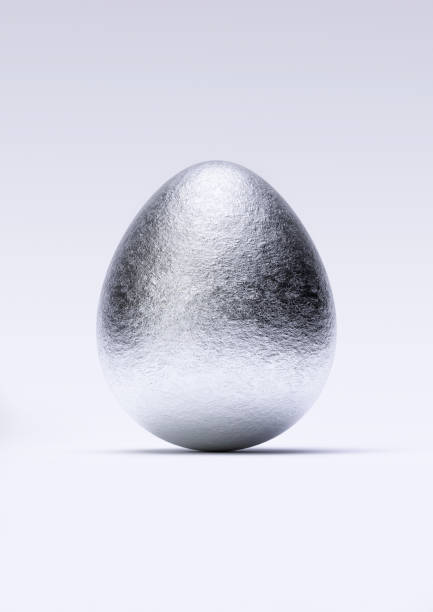 istock Chocolate easter egg with shiny silver Aluminium foil on white background. Close-up. 1390880298