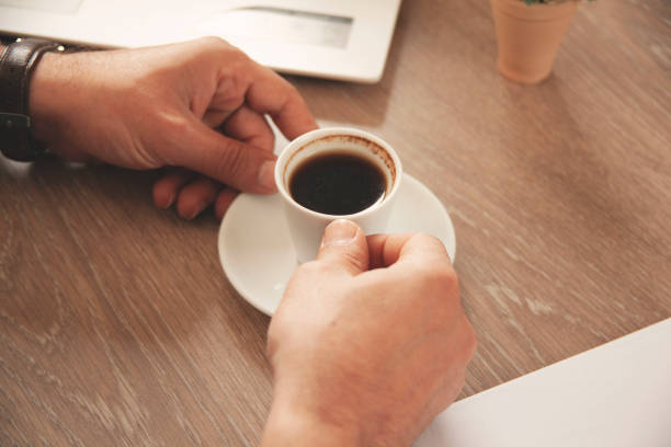 istock boss hand coffee and document on the desk 1390881560