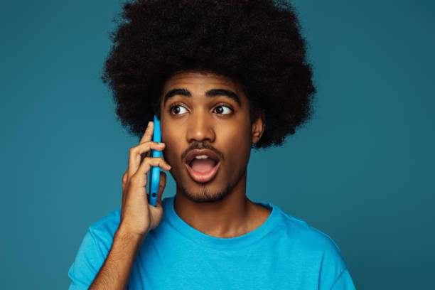 African american man with african hairstyle using phone