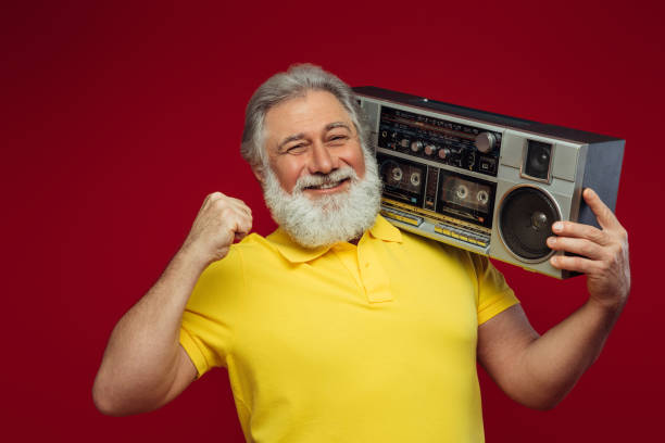 istock Old man holding with cassette boom box enjoying music 1390882729