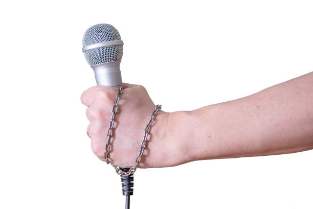 istock Female hand with microphone, on white background. 1390882951