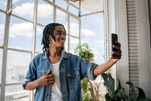 istock Young man on a video call on the mobile phone at home 1390883421