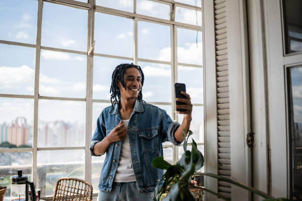 istock Young man on a video call on the mobile phone at home 1390883425