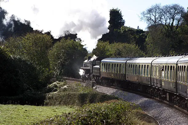 steam train travelling through the english countryside