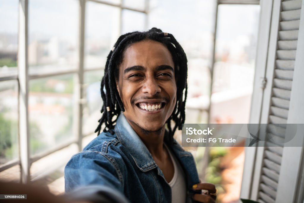 Young man on a taking selfie at home - camera point of view Young man on a video call or taking selfie at home - point of view Selfie Stock Photo