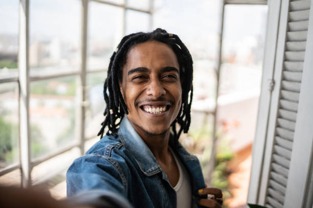 Young man on a taking selfie at home - camera point of view Young man on a video call or taking selfie at home - point of view selfie stock pictures, royalty-free photos & images