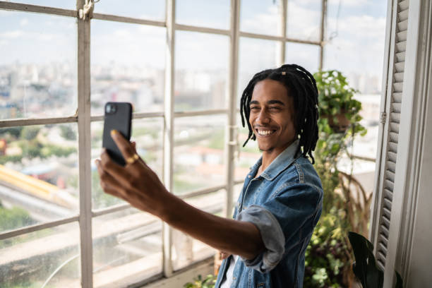 istock Young man on a video call on the mobile phone at home 1390884027