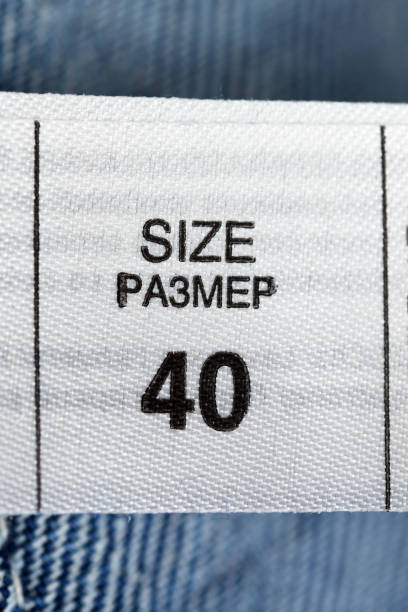 Tag on jeans. Washing tips. Clothes label, close-up.Size 40.