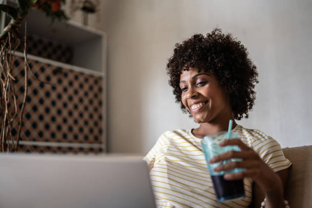 istock Young woman using the laptop at home 1390884454