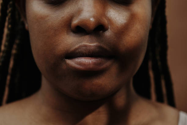 istock African young woman with closed mouth 1390884523
