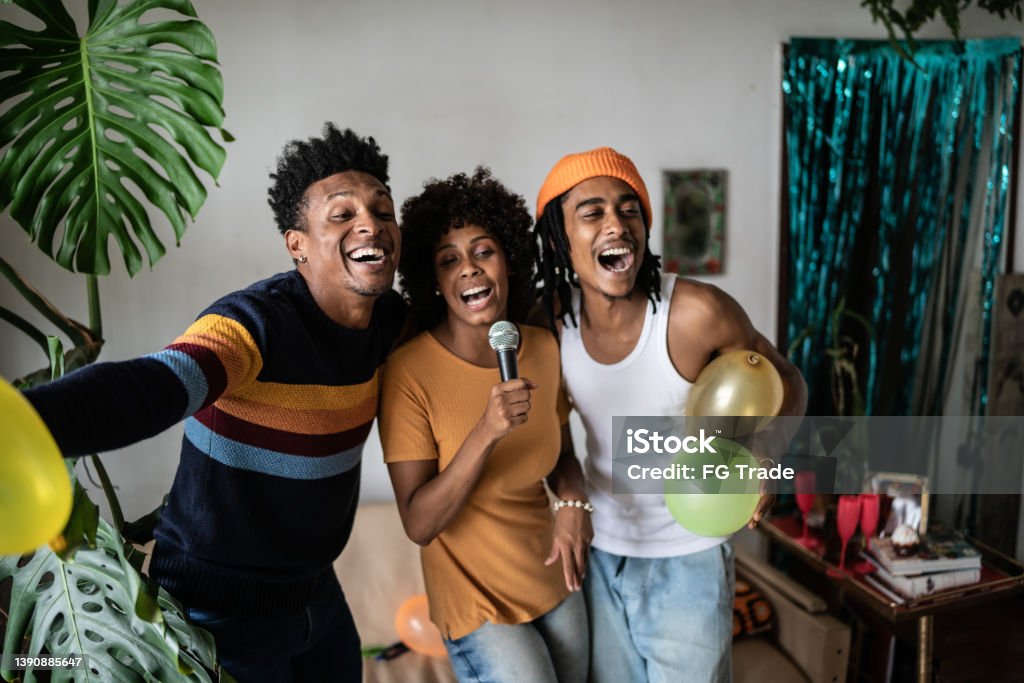 Friends singing together at home Party - Social Event Stock Photo