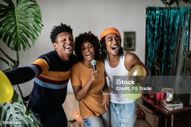 Friends Singing Together At Home Stock Photo - Download Image Now - Party - Social Event, Karaoke, Friendship