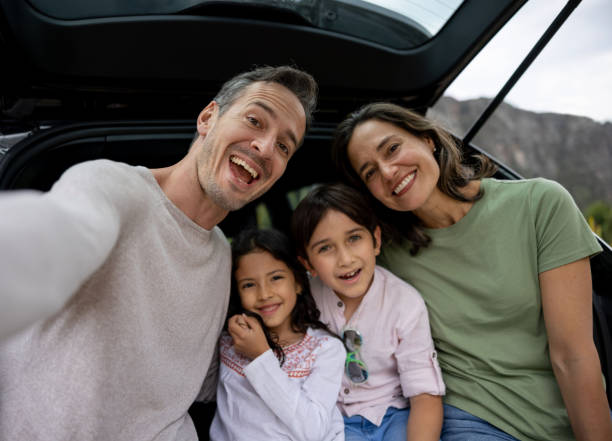 istock Happy family going on a road trip and smiling 1390886911