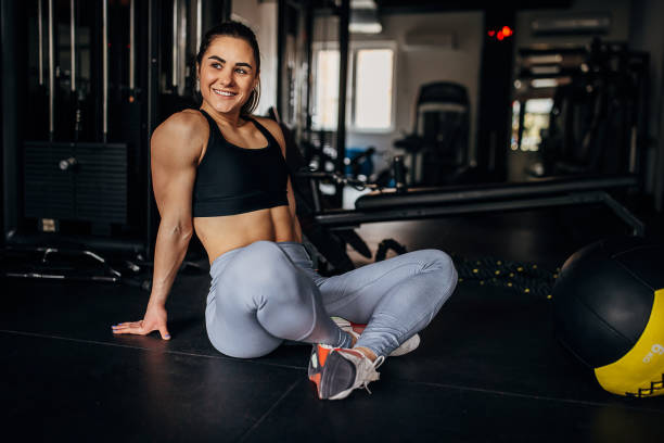 istock Fit woman sitting in gym 1390888214
