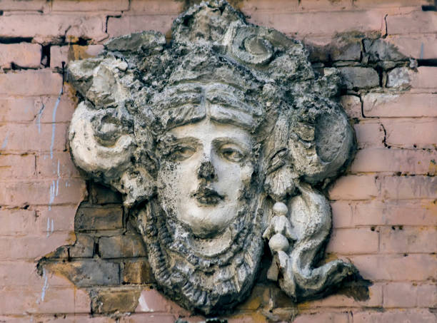 istock Ancient wall sculpture of a face woman. 1390889257