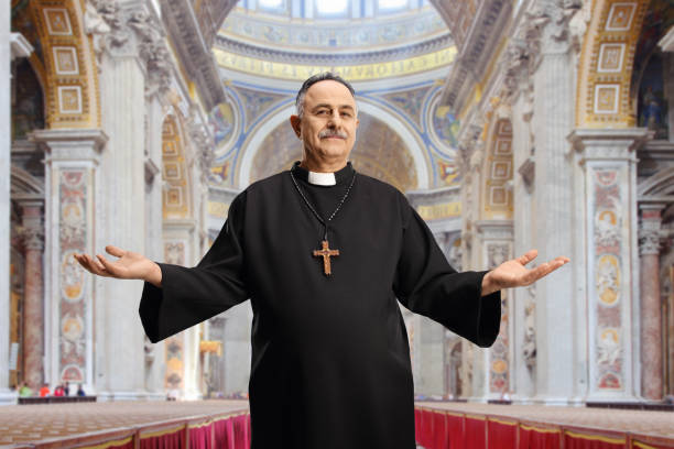 Priest spreading arms inside a cathedral