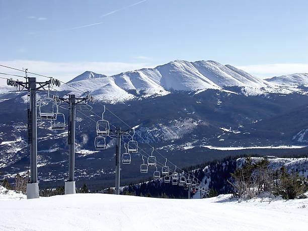 Breckenridge Chairlift A perfect picture of the 8:30 opening of a chairlift at Breckenridge, Colorado with the Rocky Mountains in the background. top of ski mountain stock pictures, royalty-free photos & images