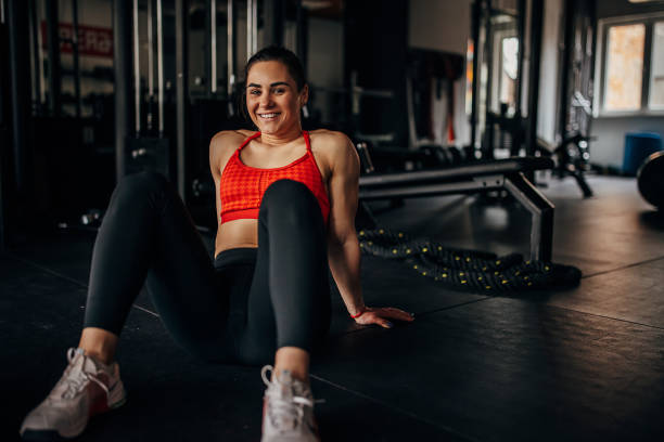 istock Fit woman sitting in gym 1390890861