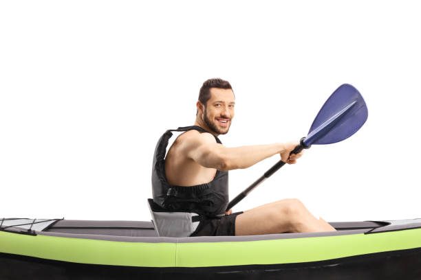 istock Man paddling a kayak and smiling at the camera 1390890883