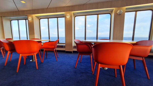 istock Chairs and tables on a ferry with sea view 1390891724