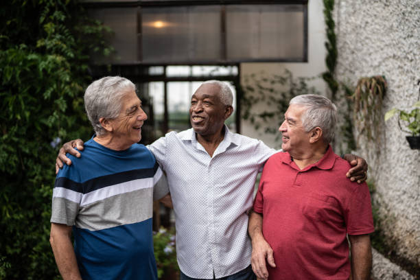 istock Happy senior friends talking at home 1390893118