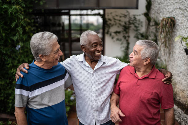 istock Happy senior friends talking at home 1390893120