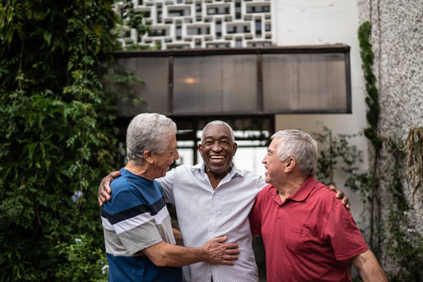 istock Happy senior friends talking at home 1390893122