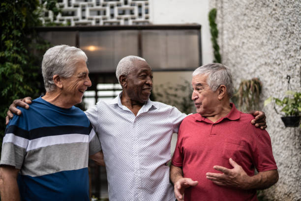 istock Happy senior friends talking at home 1390893124