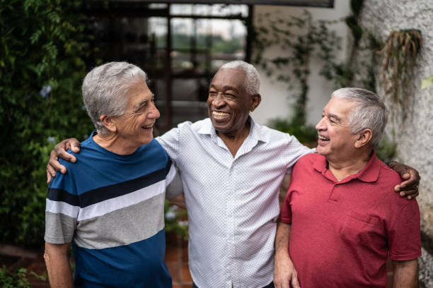 istock Happy senior friends talking at home 1390893136