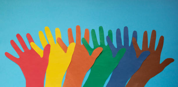 Abstract background open multicolored paper palms on a blue background.The concept of Autism Day and Youth Solidarity Day Abstract background open multicolored paper palms on a blue background.The concept of Autism Day and Youth Solidarity Day. developmental disability diversity stock pictures, royalty-free photos & images