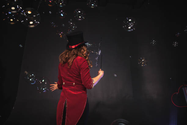 istock Female magician makes with soap bubbles show, an illusionist 1390893455