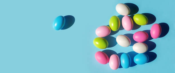 istock Multicolored painted Easter eggs on blue paper background. Flat lay  top view with copy space. Banner for congratulations. 1390893458
