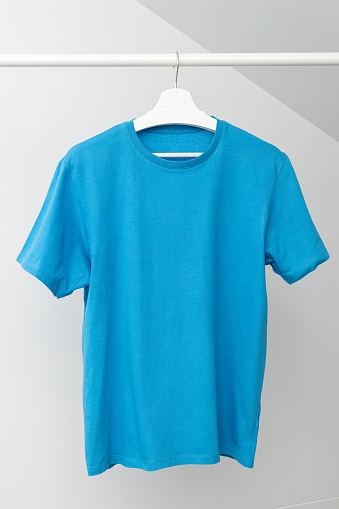 T-shirt hanging on Clothing rack. Round neck blue color. Template, mock up