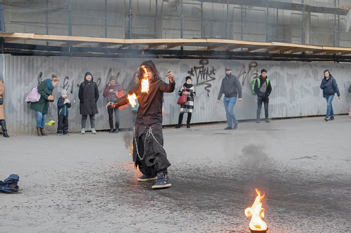 April 11, 2022, Russia, St. Petersburg, performance of a street juggler with fire