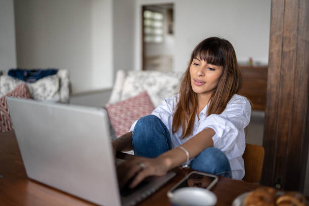 istock Young woman using the laptop at home 1390895669