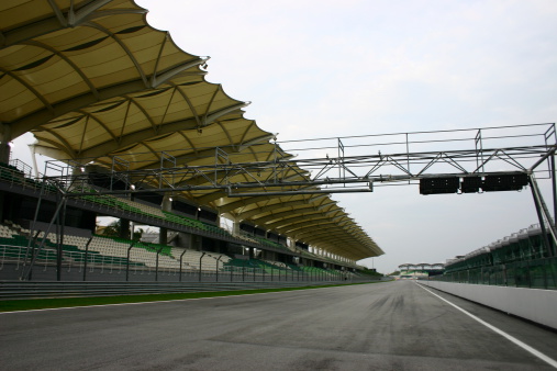 View from the pole position of a open-wheel single-seater racing car track.