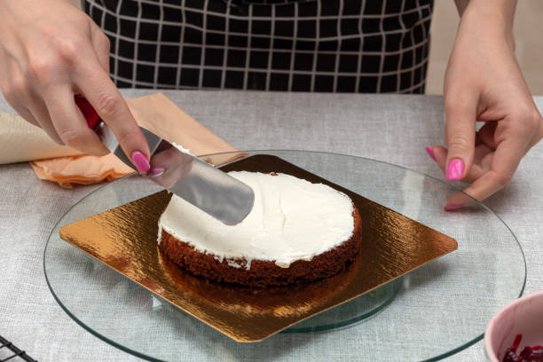 istock Leveling the cream on the sponge cake with spatula. The process of making cake. Selective focus. Picture for articles about food, confectioners. 1390896894