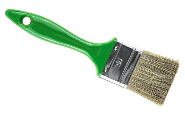istock Green paint brush isolated on a white background, top view. 1390897426